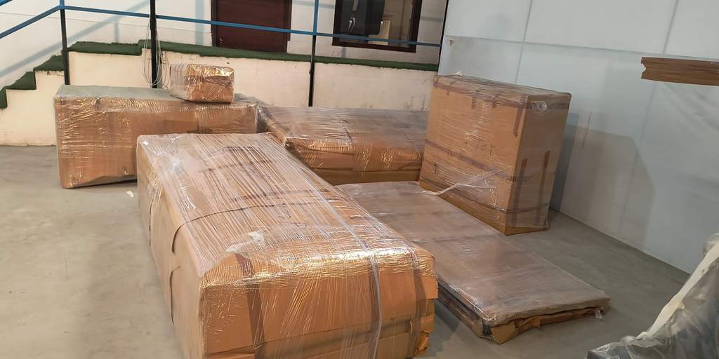 Sofa set wrapped in corrugated sheet by DLF Cargo Movers